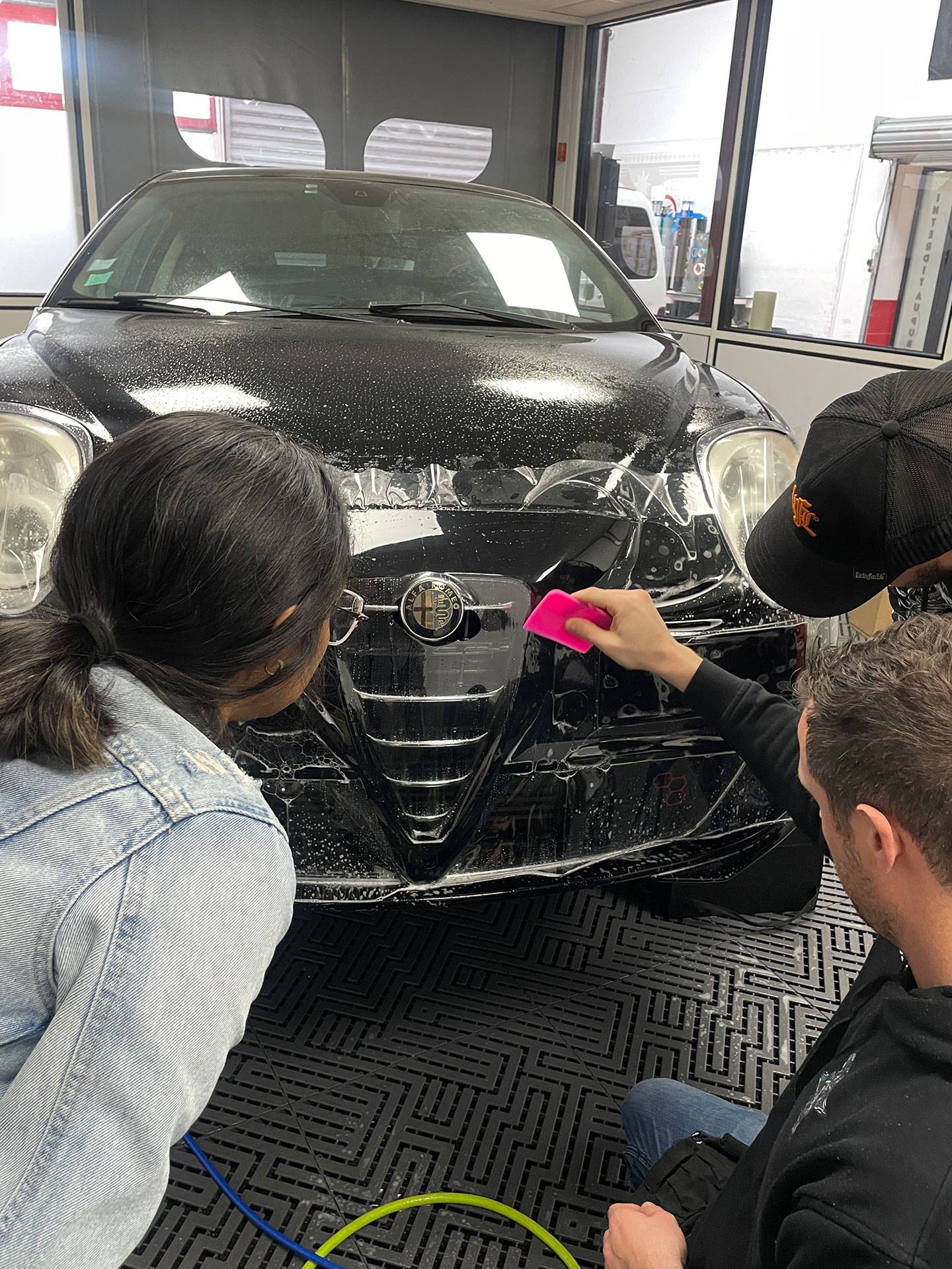 Certified car wrapper teaching advanced wrapping techniques